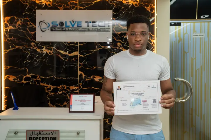 Learner holding a course certificate at Solve Tech
